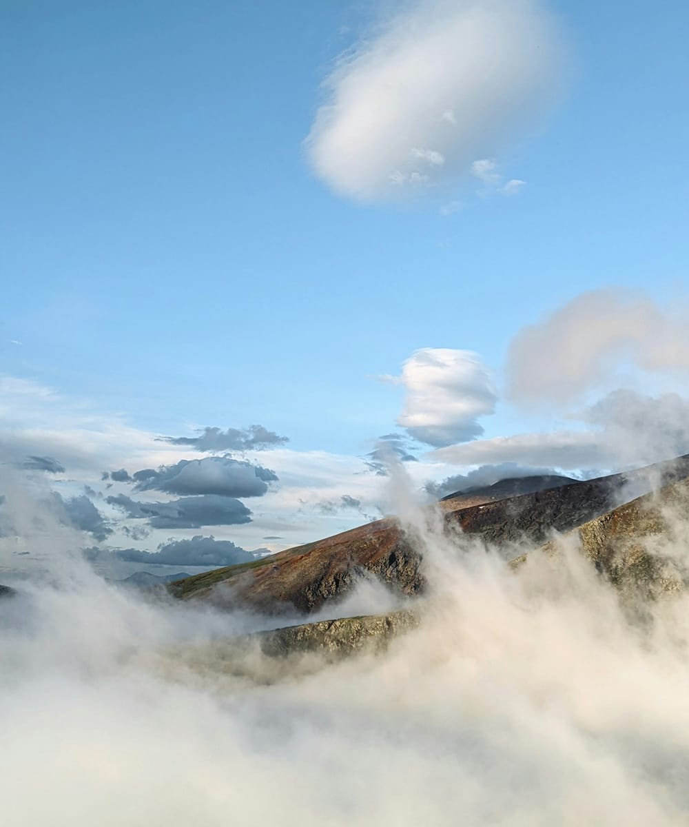 A mountain peak above a sea of cloud
